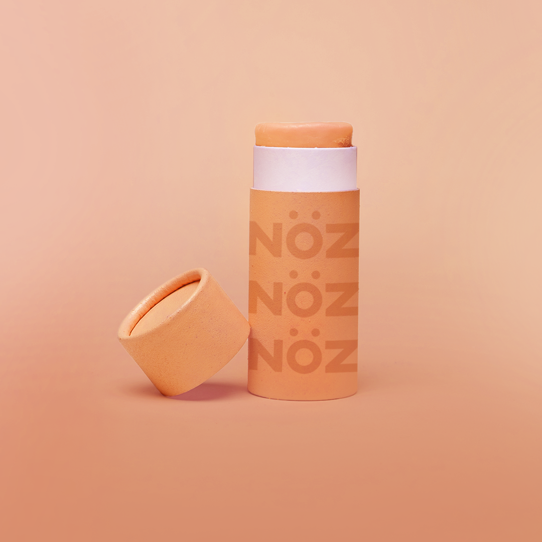 Bright orange safe vegan sunscreen with lid off